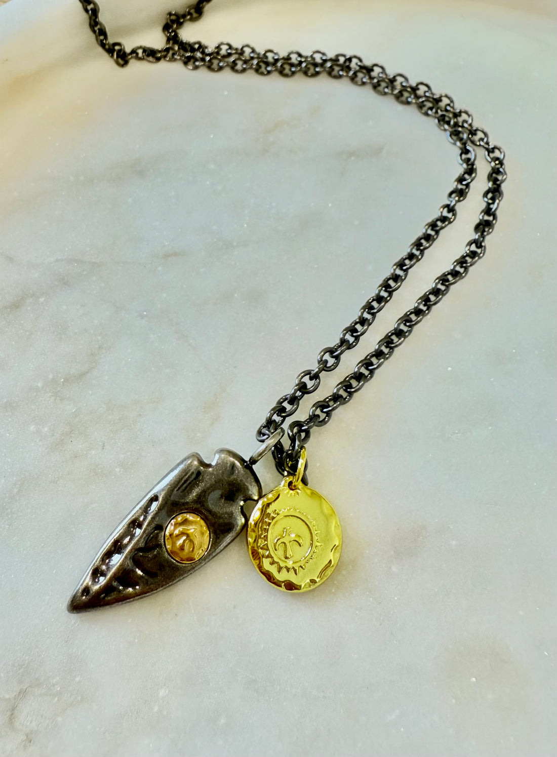 Tamsi grandinėlė su stilizuota plunksna